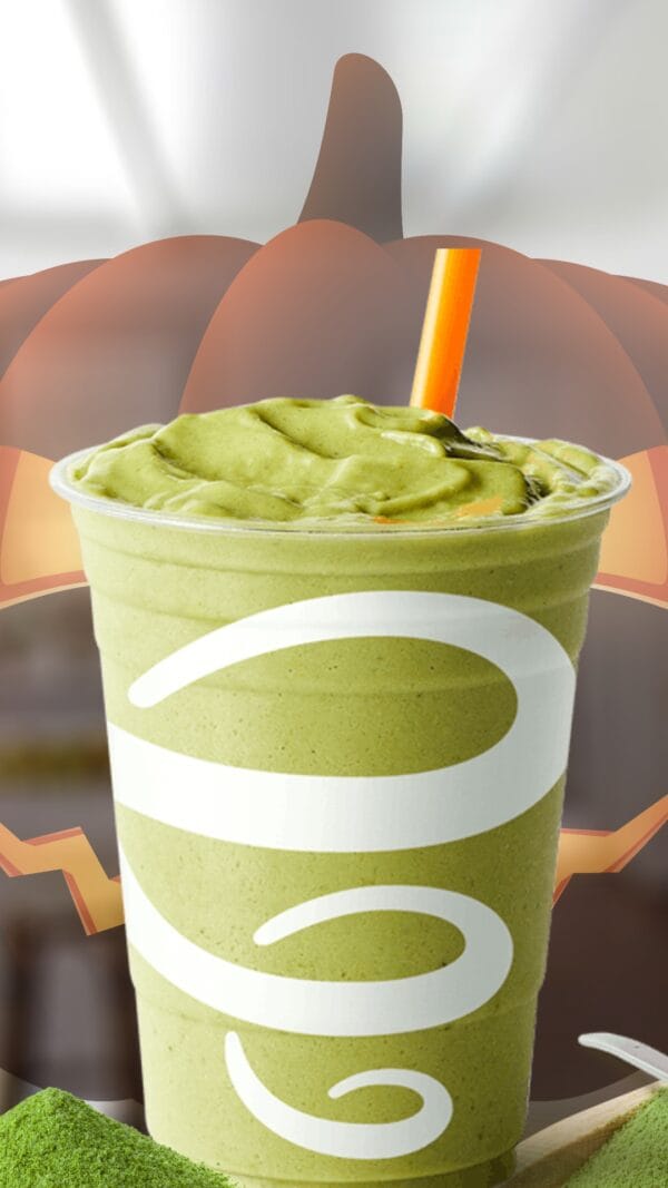 Matcha Zombie Fuel Halloween smoothie in a glass, on my kitchen counter, surrounded by fresh matcha green tea powder.